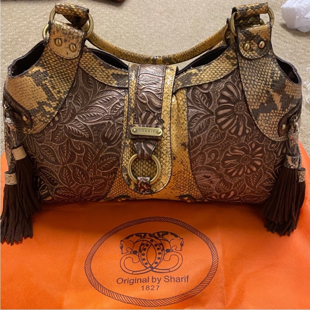 Authentic SHARIF EMBOSSED LEATHER BAG WITH TASSELS AND GOLD TONE DETAILS.